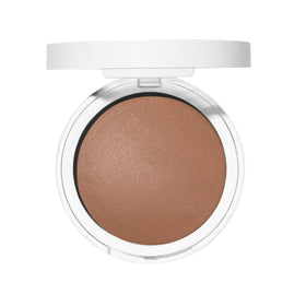 Well People bronzer held in hand for scale showing travel-friendly size and portability