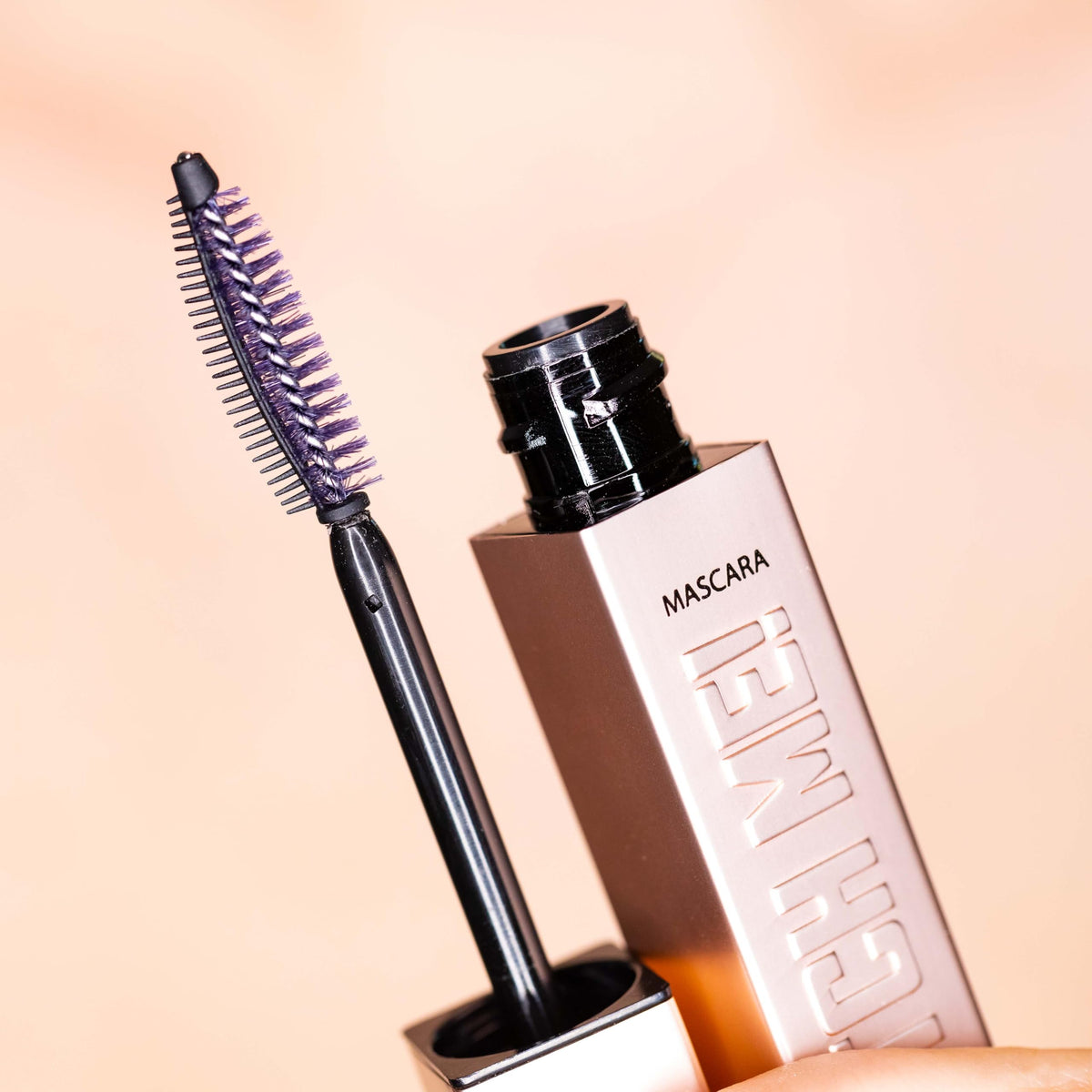 Whats Up Nails mascara next to ruler showing 10 ml tube scale and travel-friendly size