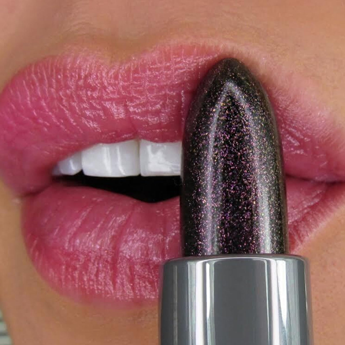 Winky Lux swatch on lips displaying personalized mauve tint and subtle shimmer benefit