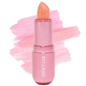 Winky Lux front packaging showcasing compact jewel balm and playful branding benefits