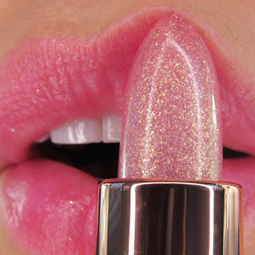 Winky Lux swatch on wrist showing personalized pink tint benefit