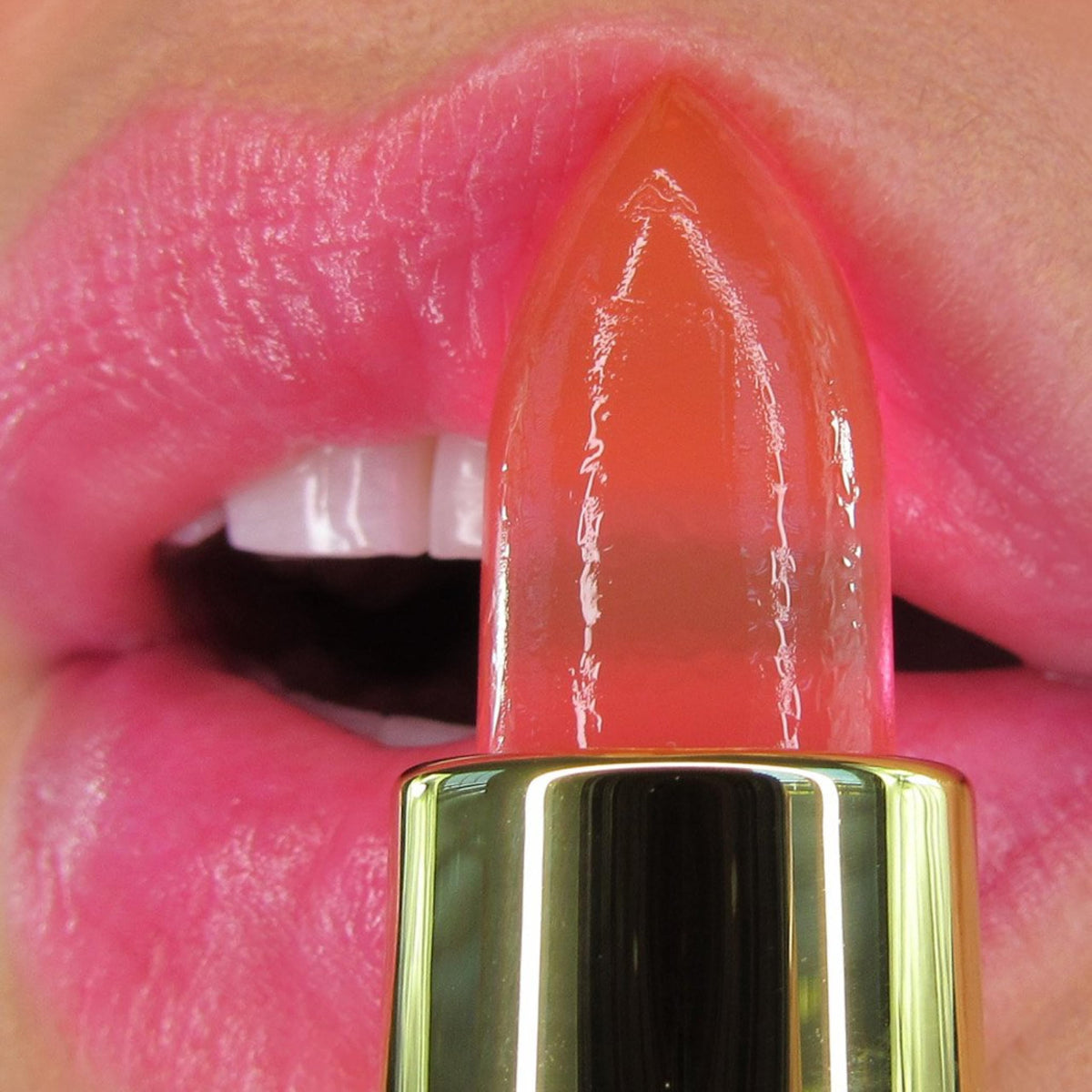 Winky Lux balm applied on lips demonstrating sheer pink tint and glossy finish