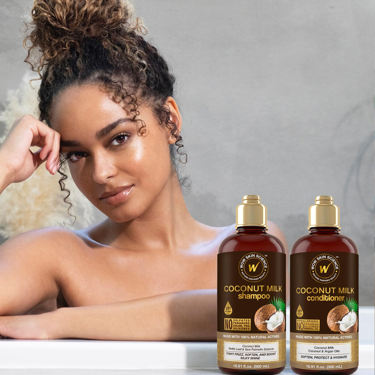 WOW Skin Science conditioner being applied to curly hair demonstrating improved manageability