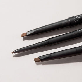 WUNDERBROW Brunette dual-ended pencil held for scale demonstrating travel convenience