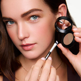 WUNDERBROW compact in a hand to show scale and pocket-friendly size