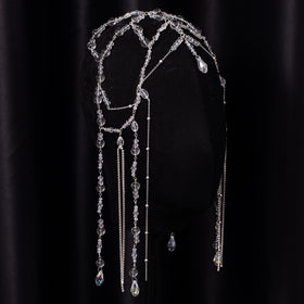 Xerling headpiece held in hand to show scale and easy travel-friendly size