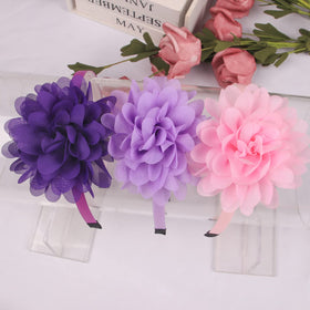 XIMA headband worn by child in lifestyle scene showing fit and pretty floral accent for photos