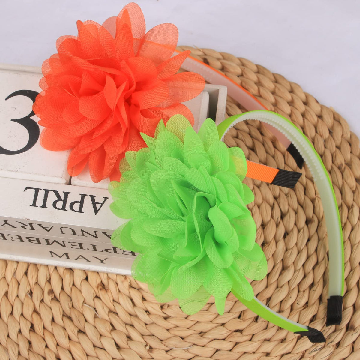 XIMA headband beside ruler showing 4 inch flower size and band width for accurate sizing