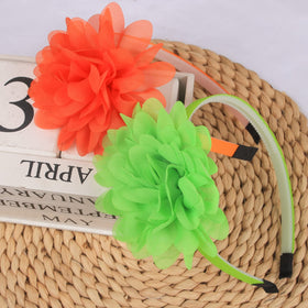 XIMA headband beside ruler showing 4 inch flower size and band width for accurate sizing