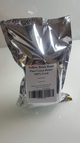 Yellow Brick Rd cocoa butter in a homemade balm jar applied to skin demonstrating smooth moisturizing benefit