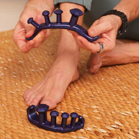 YogaToes Gems on bedside table in lifestyle scene supporting nightly recovery