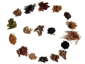 YOGI’S GIFT herbs steeping in carrier oil jar, demonstrating easy infusion method and convenience benefit