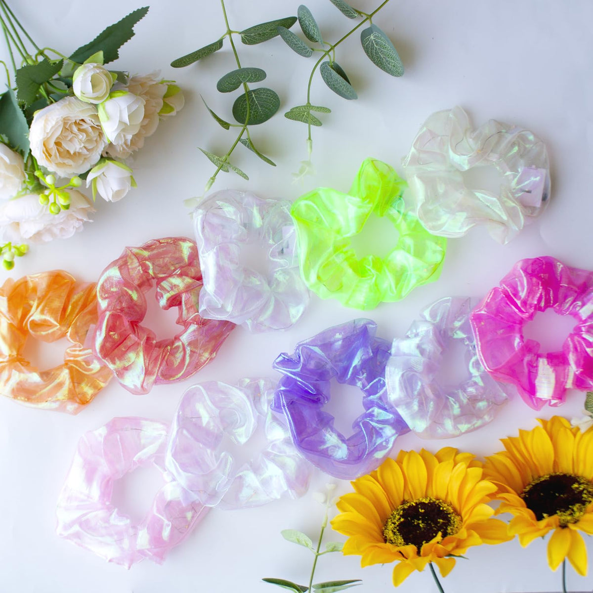 Yomwig scrunchies styled on a table at a Christmas party showing festive glow appeal