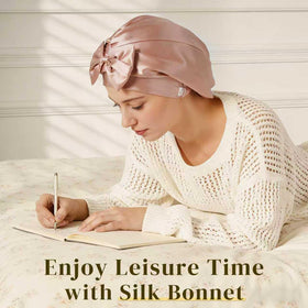 ZIMASILK bonnet beside hand for scale showing fit and lightweight convenience
