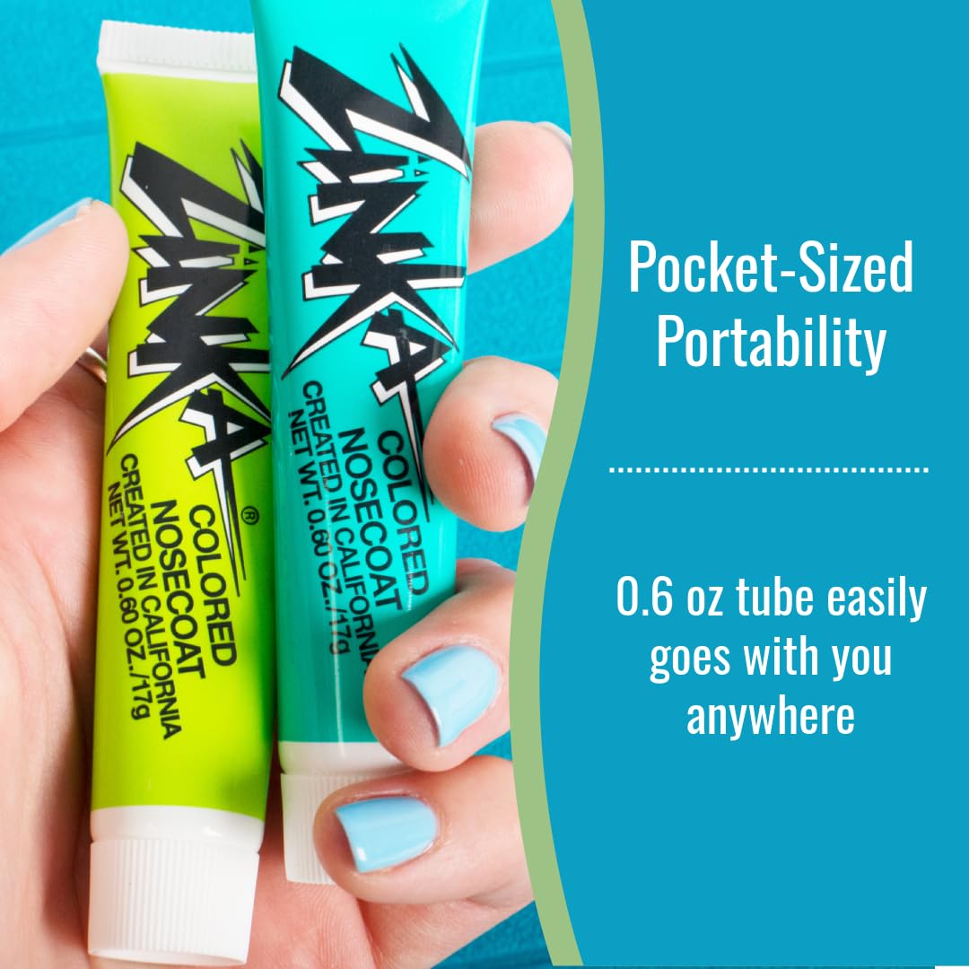 Zinka next to coin for scale illustrating travel-friendly size