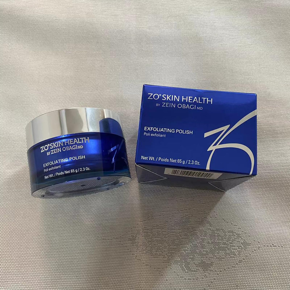 Zo-SKIN HEALTH polish on bathroom shelf staged with towels to suggest routine refresh benefit